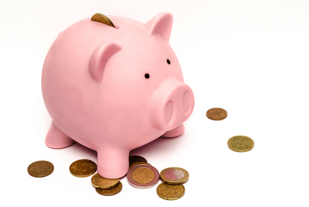 Piggy bank with coins around it