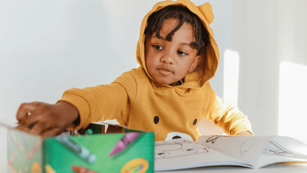 Child sat at the table drawing