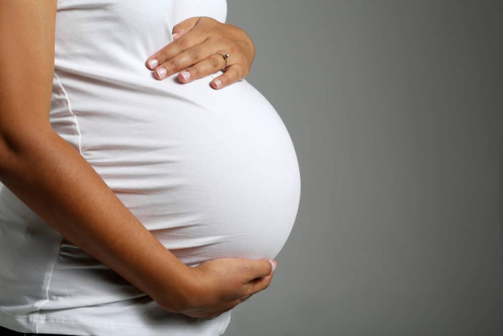 Pregnant women holding their baby bump