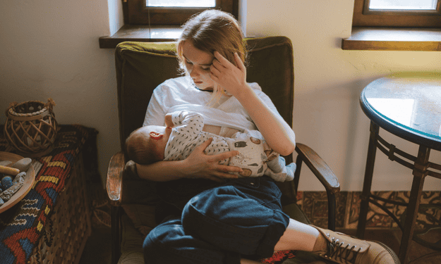 Young mother breastfeeding her baby