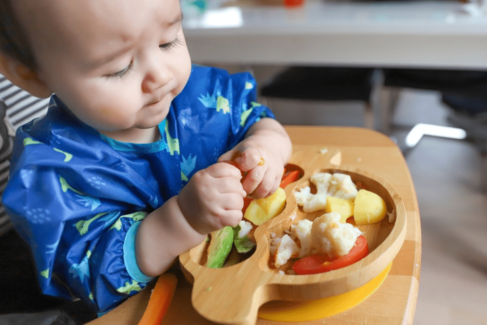Baby eating finger foods