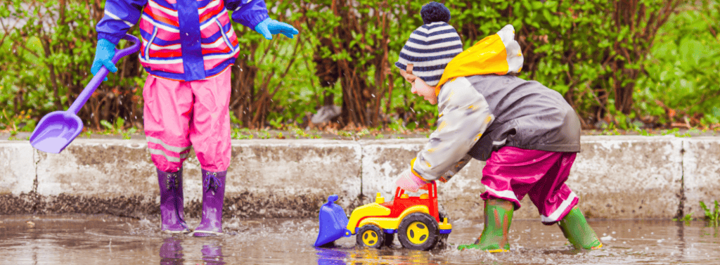 Children playing outside in the rain