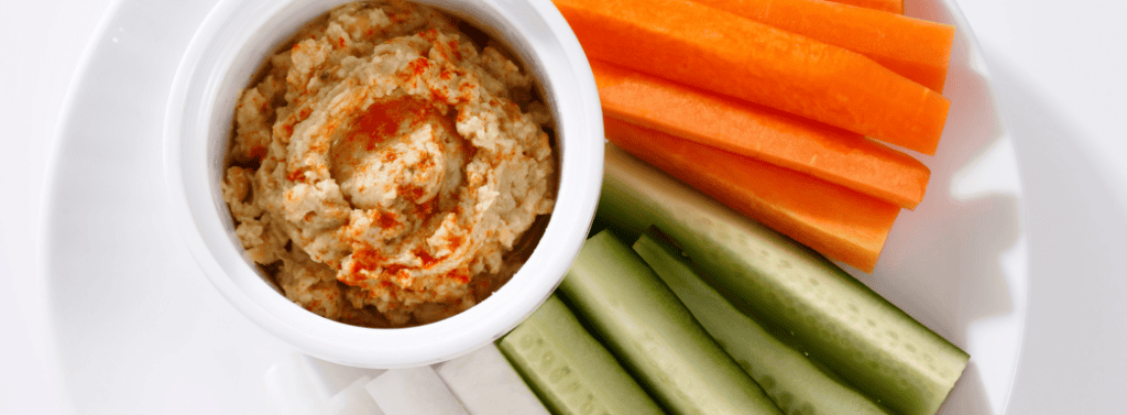 Carrot and cucumber stick with hummus