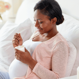 Pregnant women eating a yoghurt