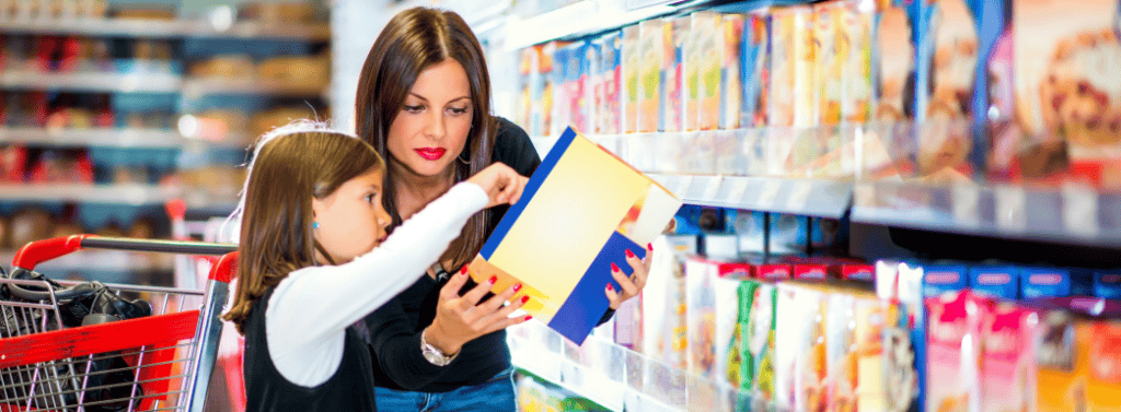 Mum and daughter reading food labels at the supermarket