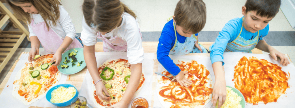 Children making homemade pizza
