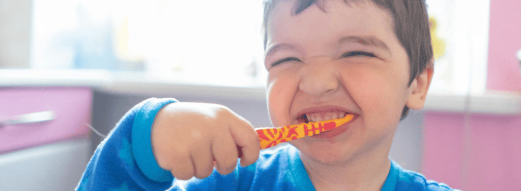 Boy brushing his teeth at home