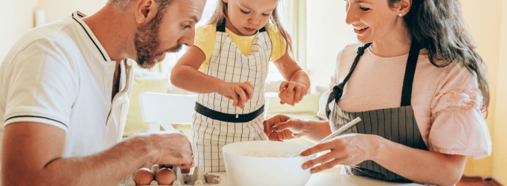 Family making pancakes at home in the kitchen