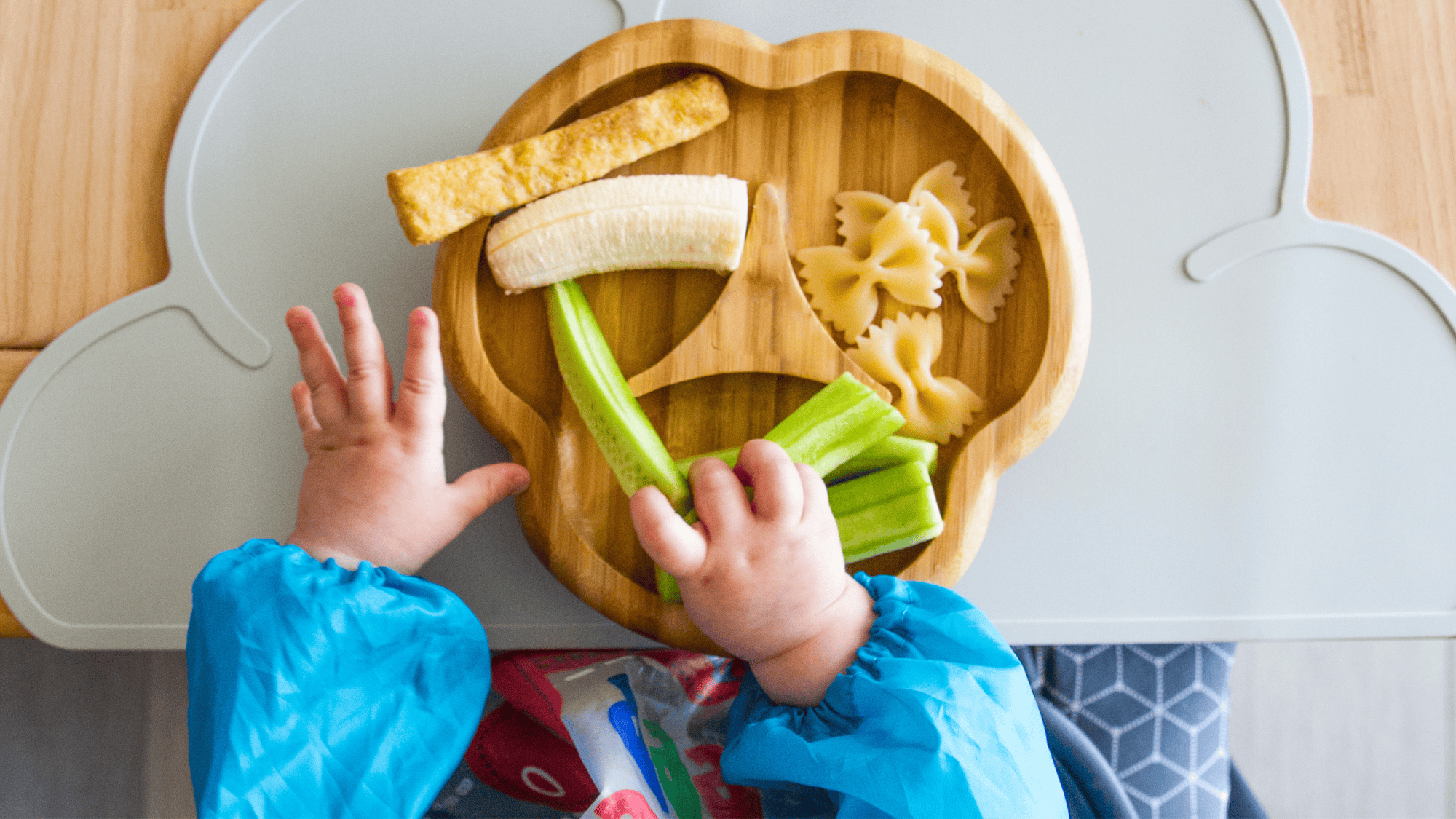A child feeding themselves from a plate