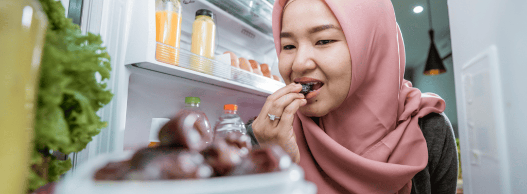 Muslim women eating dates