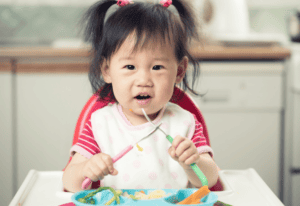 Happy Toddler Eating Meal