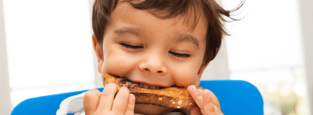 Child eating toast for breakfast